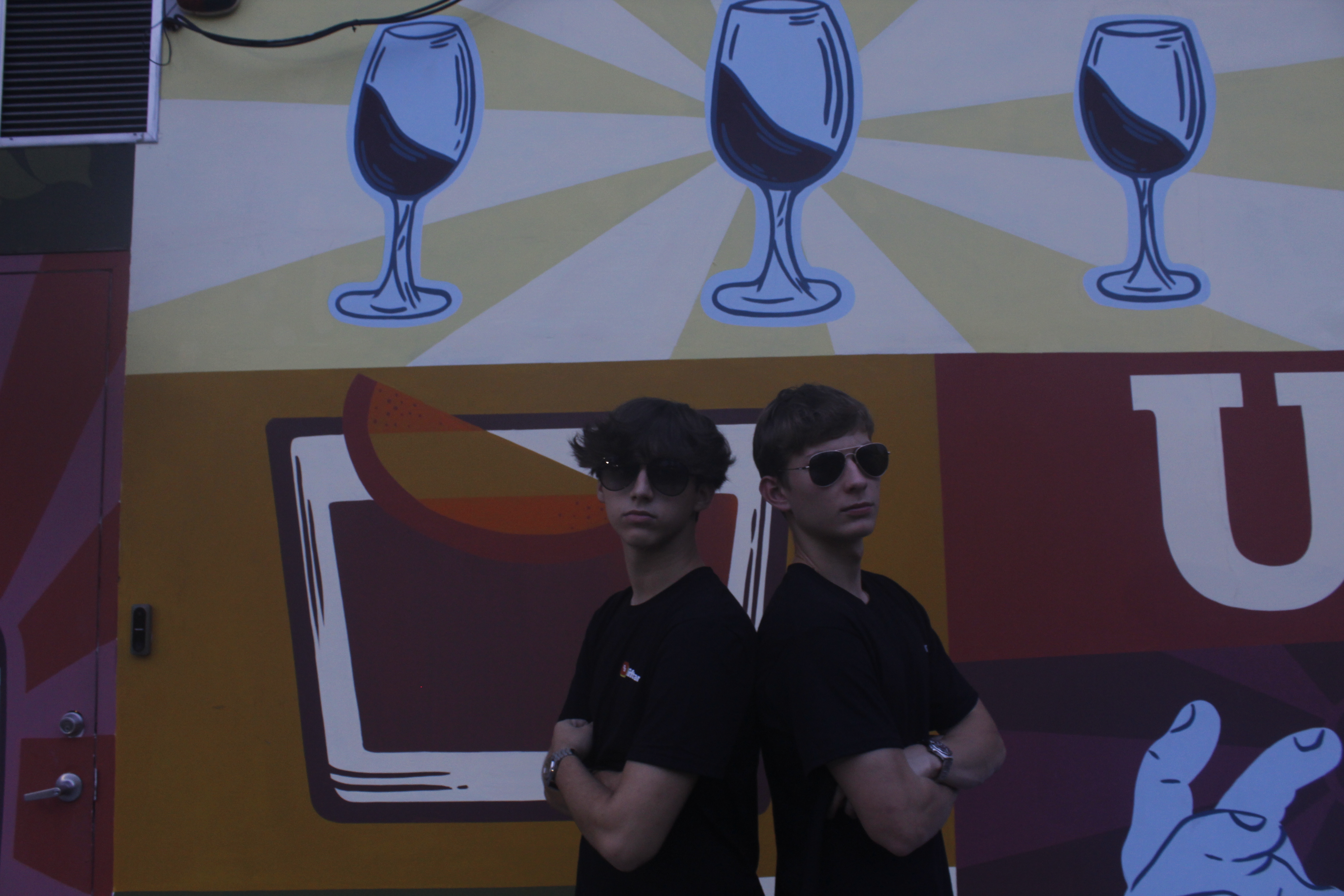 Two people wearing black Liftrank T-shirts